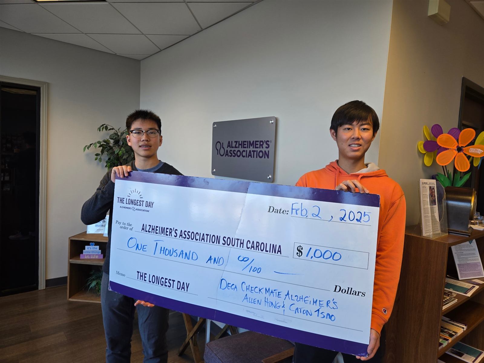 Co-founders Caton Tsao and Allen Hong presenting a fundraising check to the Alzheimer's Association